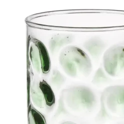 Glas met groene stippen